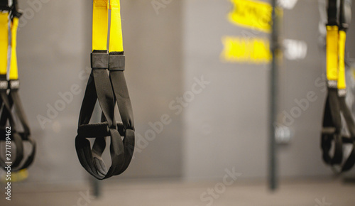 Trx straps in urban modern gym. A fitness equipment called trx that was prepared for playing at noon in a gym.