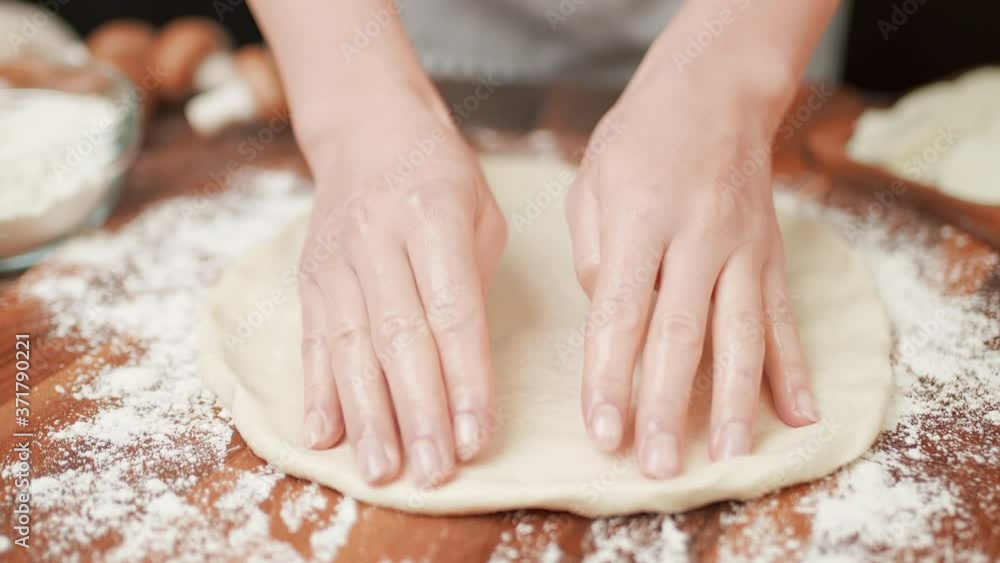 Close-up of stretching a pizza dough in slow-motion in 4K. Close-up of stretching a pizza dough in slow-motion in 4K.