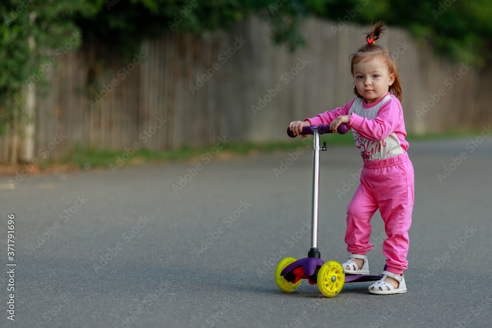 little beautiful girl riding scooter at street little beautiful girl riding scooter at street