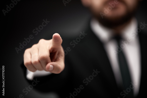 Man pointing finger forward, towards you