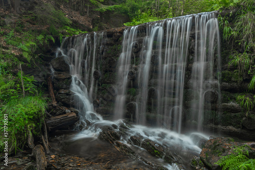 Waterfall on Divoky creek near Kouty nad Desnou village in summer day