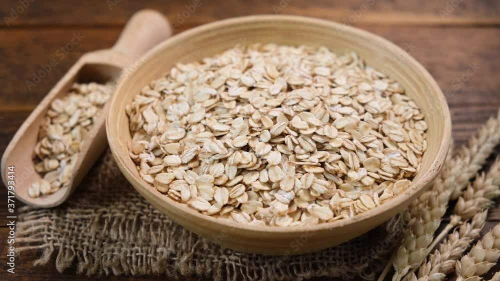 Oats in a bowl on linen rag. Healthy food concept Oats in a bowl on linen rag. Healthy food concept