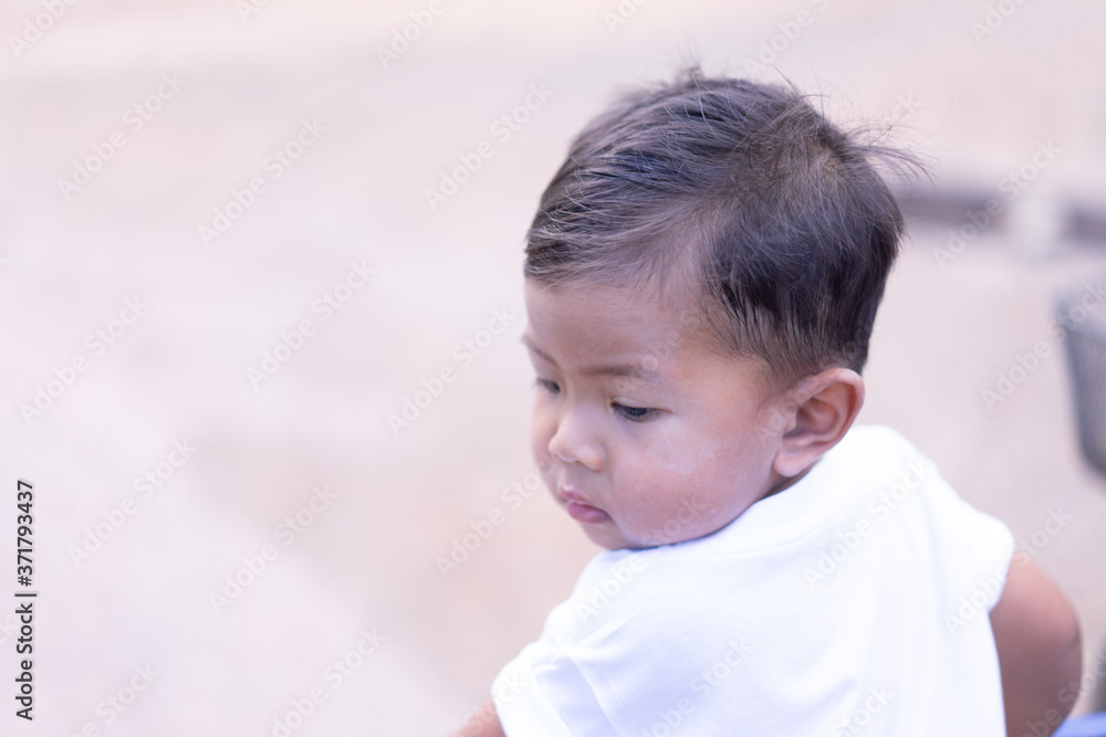 Asian boy wearing a white shirt looking back Asian boy wearing a white shirt looking back