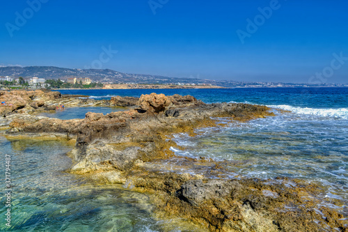 View of the rocky sea coast of the Mediterranean Sea in Paphos  Cyprus.  Coastal reefs and small puddles filled with sea water.
