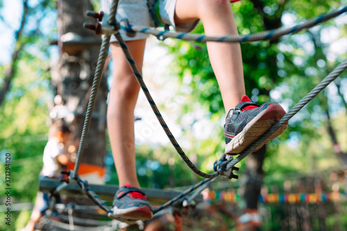 Rope Park. close - up of a child's feet passing an obstacle.