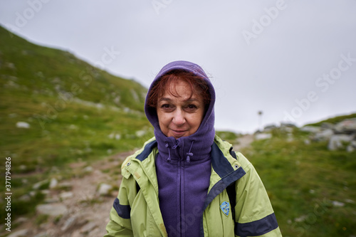 Woman hiking on a trail in the mountains © Xalanx
