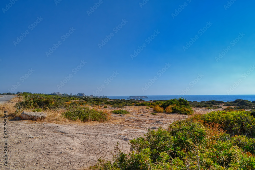 View of the Mediterranean sea panorama.  Stone-sandy landscape with rare vegetation and the sea coast.