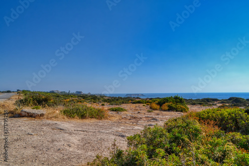 View of the Mediterranean sea panorama.  Stone-sandy landscape with rare vegetation and the sea coast.