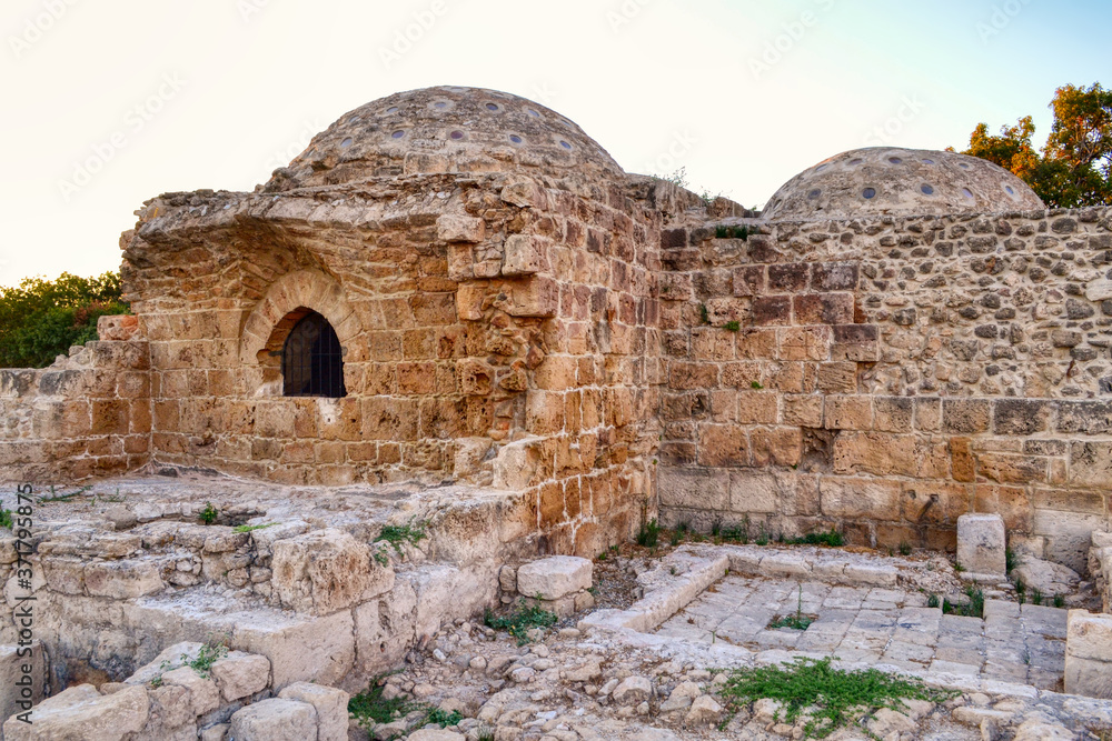 The ruins of medieval baths among the streets of Paphos, Cyprus.  Low ancient buildings with domes built of sand blocks.