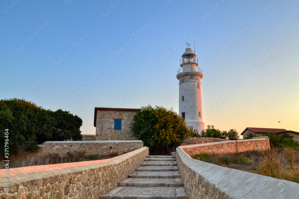 A lighthouse located amidst an archaeological site in Paphos, Cyprus.  Staircase leading to the lighthouse, lit by the sun at sunset.