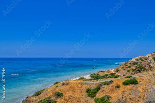 View of the Aphrodite's beach from the mountain observation platform on a sunny hot day. The famous beach on the island of Cyprus, near the town of Paphos.