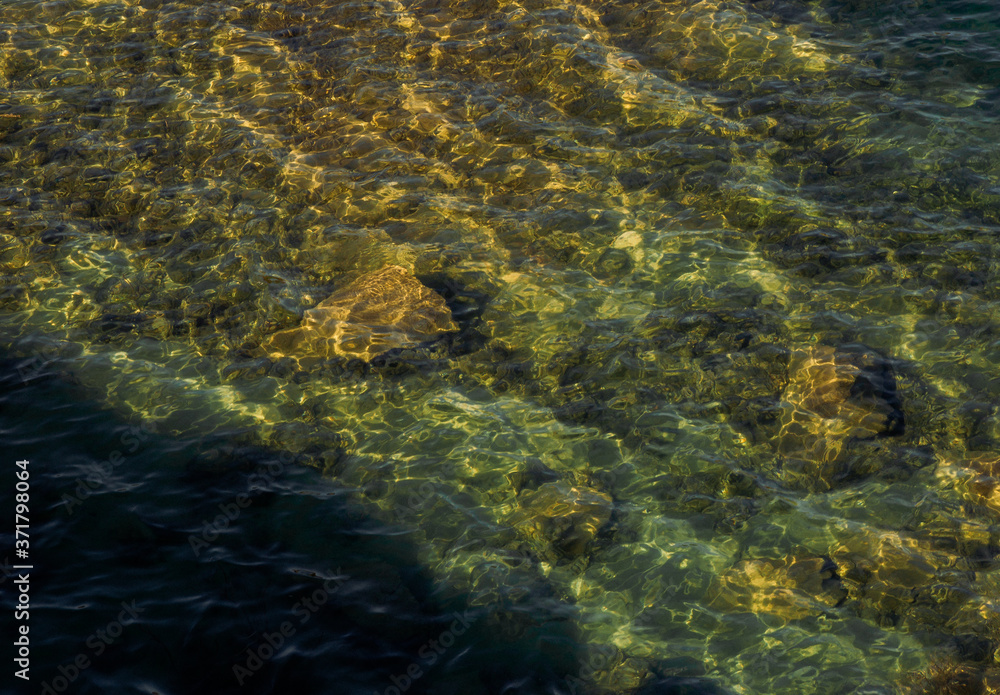 stones are visible through clear water stones are visible through clear water