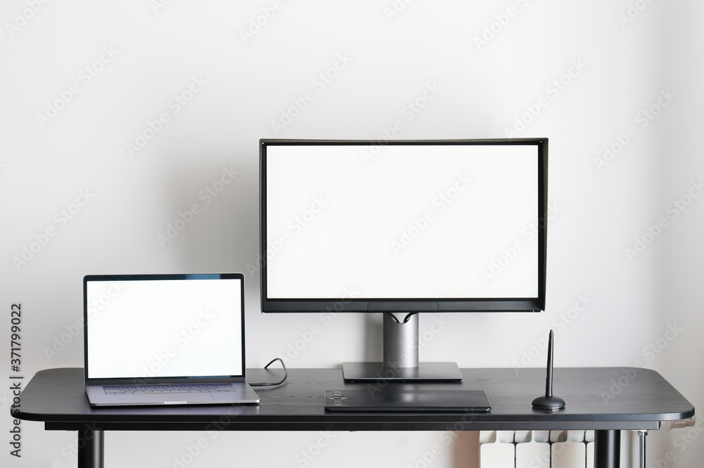 Desk with laptop and computer monitor Desk with laptop and computer monitor