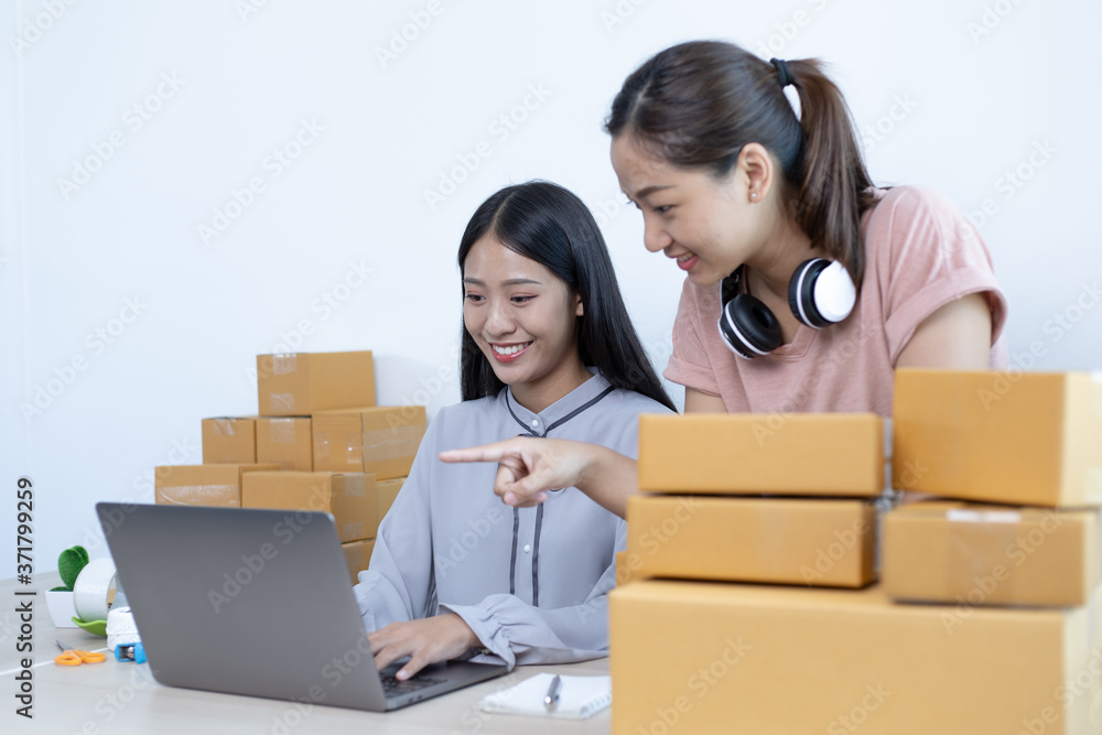 Two young Asian women are helping to sell their products online on the Internet. Two young Asian women are helping to sell their products online on the Internet.