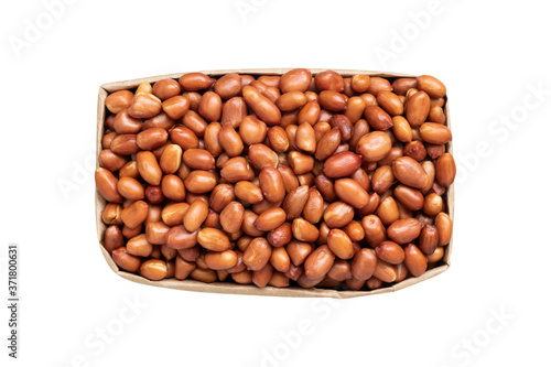 top view of roasted red skin peanuts in paper bag isolated on white background