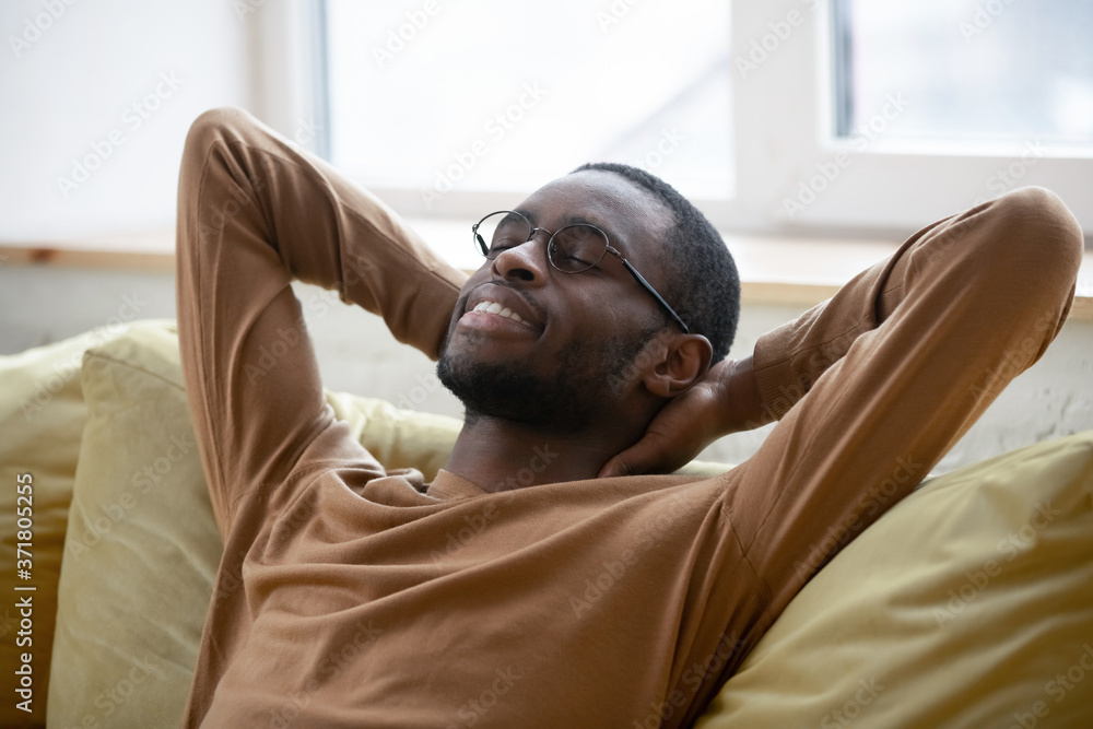 African American Guy Relaxing With Eyes Closed Sitting On Sofa