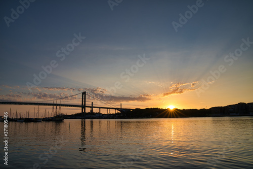 Bridge, tranquil ocean and dramatic sunset