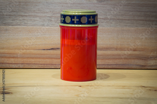 red corpse candle with wooden background