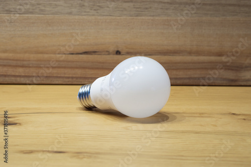 white light bulb with wooden background