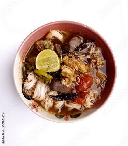 Spicy rice noodle with pork (Khanom Jeen Nam Ngiao) isolated on white background. The recommended Northern Thai dish.