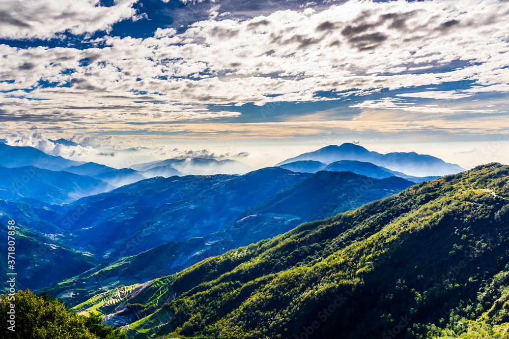 Layers of magnificent mountains and clear clouds background in the morning 