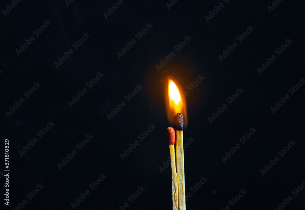 Couple of matches burning together with heat flame isolated on a black background. Couple of matches burning together with heat flame isolated on a black background.