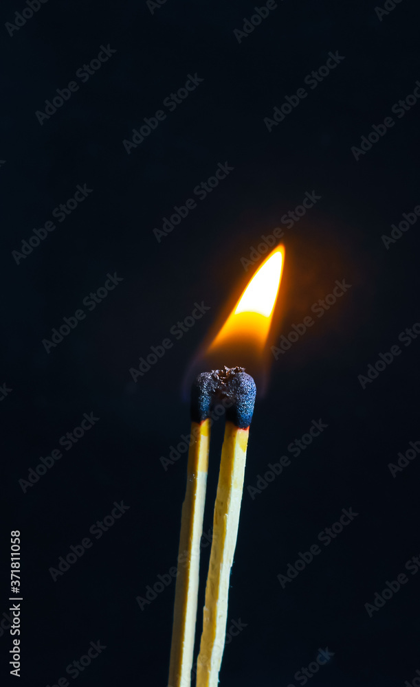 Couple of matches burning together with heat flame isolated on a black background. Couple of matches burning together with heat flame isolated on a black background.