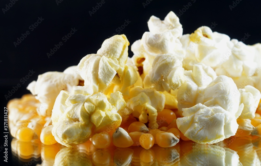 Extreme close up of pop corn some grains popped some unpopped on a black background
Extreme close up of pop corn some grains popped some unpopped on a black background
