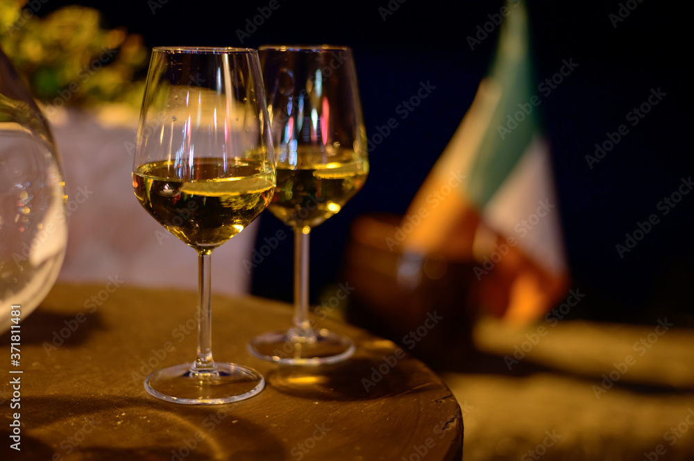 Two glasses of cold dry white wine served outdoor in cafe at night in Italy Two glasses of cold dry white wine served outdoor in cafe at night in Italy