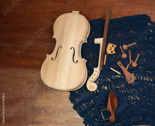 Raw violin and accessories put on background