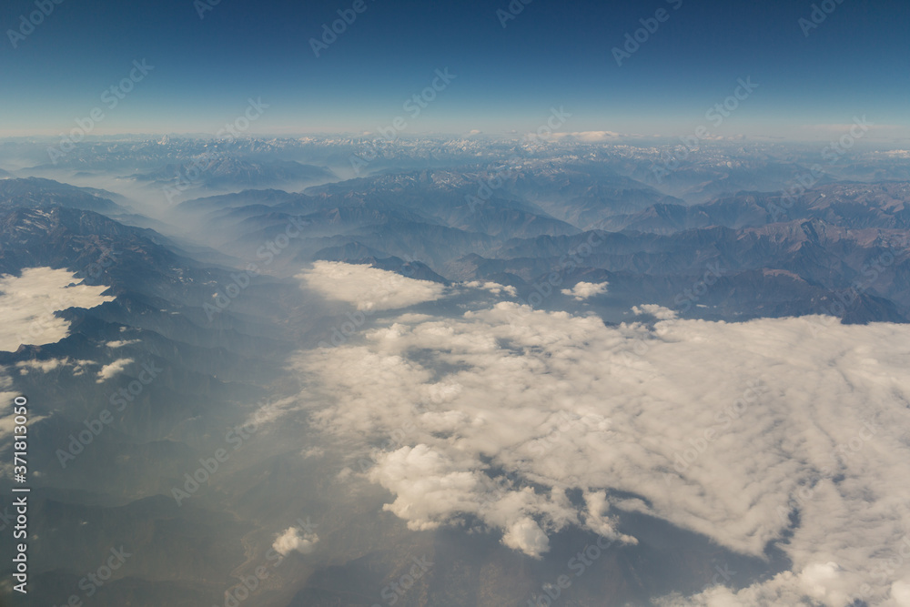 View of the mountain landscape from the plane in the afternoon