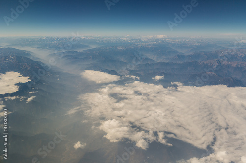 View of the mountain landscape from the plane in the afternoon