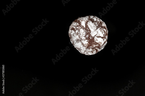Obraz na płótnie Homemade cookies with chocolate chips with powdered sugar on black background. Freshly baked choco cookie close up. Dark food. Cook at home. w salonie