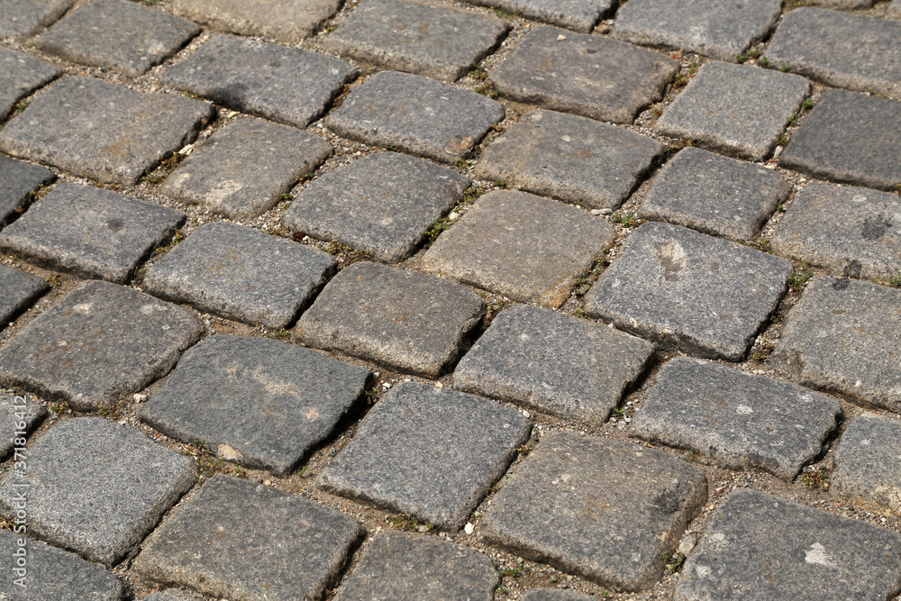 Abstract background of old cobblestone pavement close-up Abstract background of old cobblestone pavement close-up