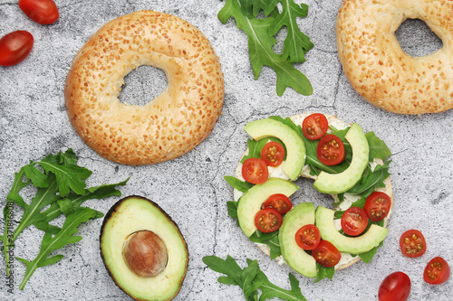 Sesame bagels with tomatoes and avocado