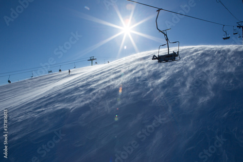 Chair lift, on a bright winter day in the village of Sheregesh, top Green