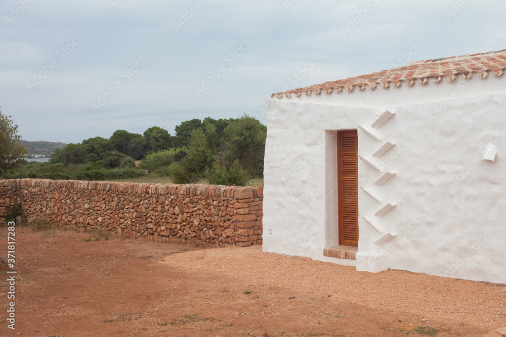 Typical white house in the Balearic Islands with a drain.