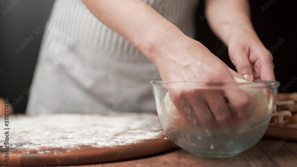 Close-up shot of stretching pizza dough making it thinner in 4k. Concept of preparing slim dough in slow-motion. Close-up shot of stretching pizza dough making it thinner in 4k. Concept of preparing slim dough in slow-motion.
