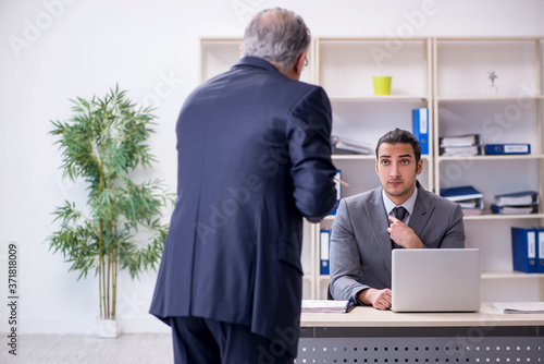 Old and young businessmen in business meeting concept