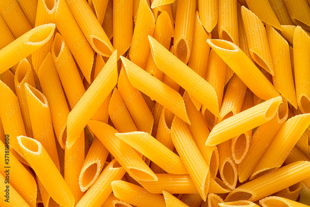 Raw dried Italian penne pasta tubes Raw dried Italian penne pasta tubes