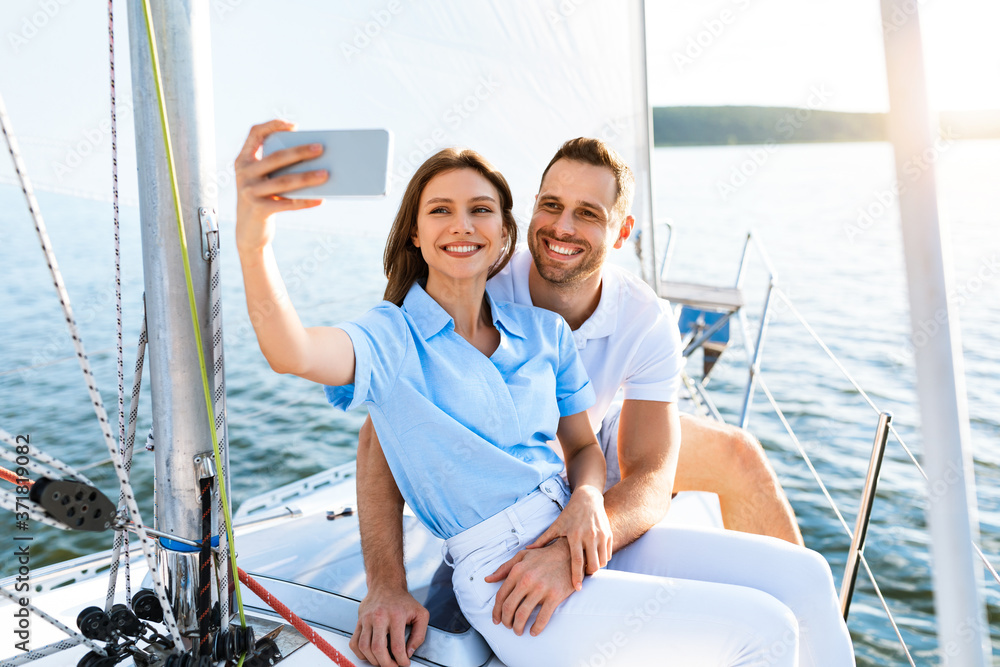 Spouses On Cruise Yacht Making Selfie Standing On Deck Outside