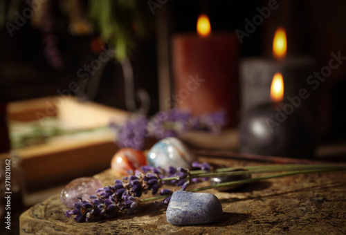 Gemstones and healing herbs on wooden board