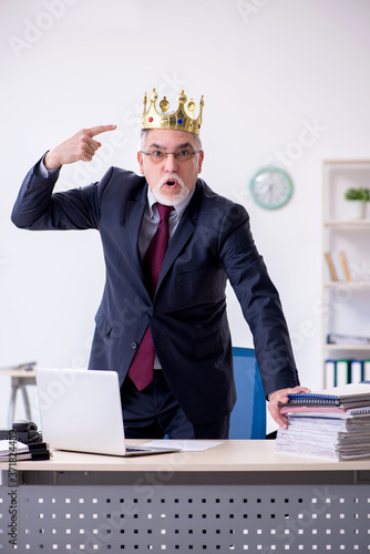 Old king businessman employee at workplace photo