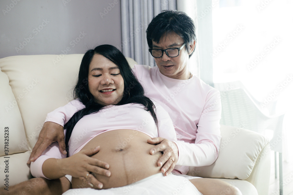 Happiness pregnant woman with husband in relaxation room at home. Happiness pregnant woman with husband in relaxation room at home.