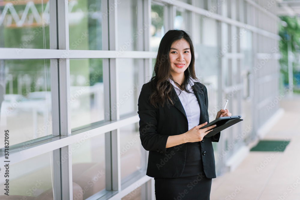 Beautiful young asian woman using tablet pc Beautiful young asian woman using tablet pc
