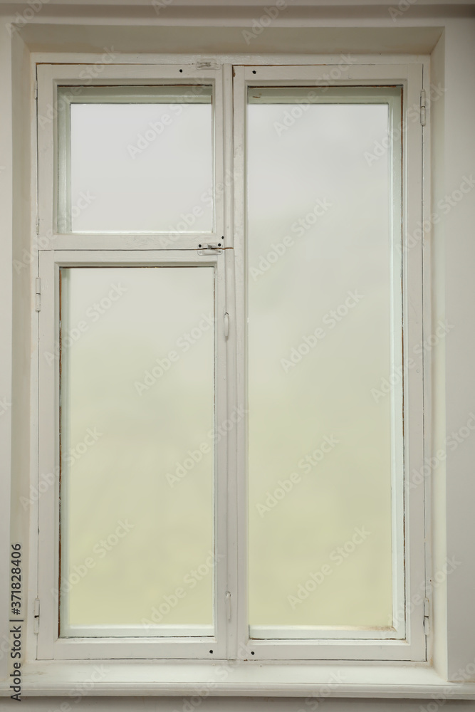 Old white window with wooden sill in room Old white window with wooden sill in room