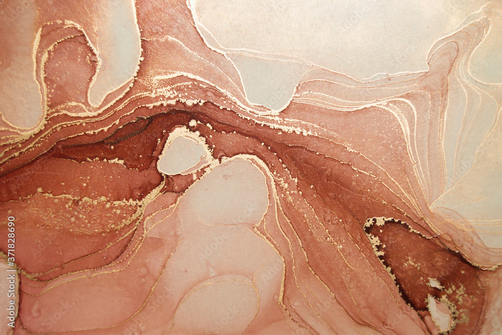 Fototapeta premium Luxury abstract fluid art painting in alcohol ink technique, mixture of orange and brown paints. Imitation of marble amber stone cut, glowing golden veins. Tender and dreamy design.