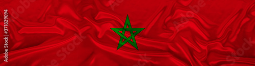 long panorama of the national flag of the state of Morocco with the coat of arms on delicate silk with folds, the concept of tourism, freedom, choice, economy, politics, global world trade