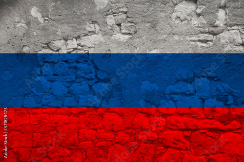 national flag of the state of Russia on an old stone wall with cracks, the concept of tourism, emigration, economy, politics, global world trade