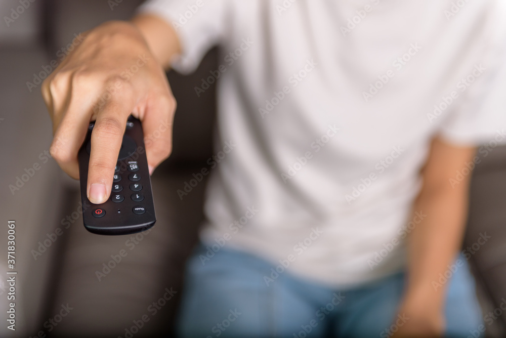 Hand using pushing the remote control button to turn off the TV Stock ...